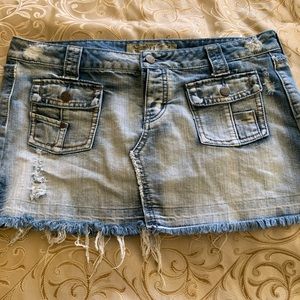 Light wash distressed denim miniskirt